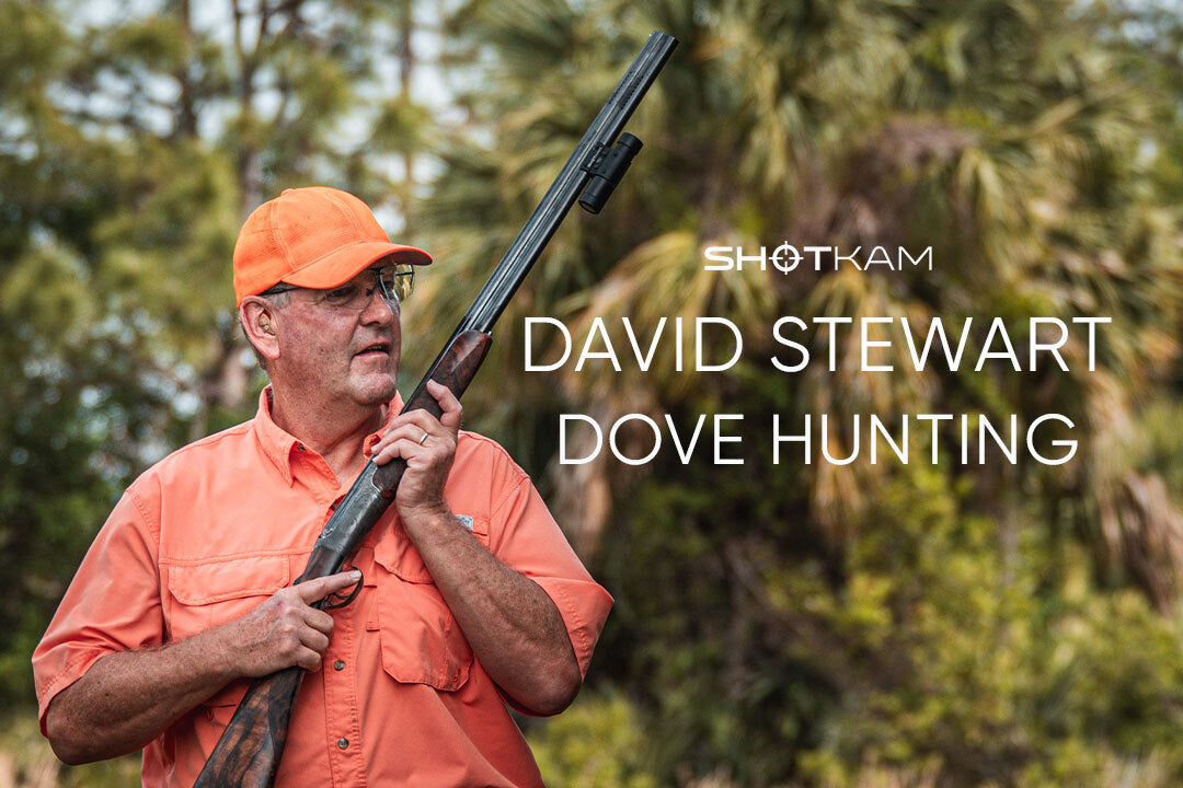 Man in orange hunting gear holding shotgun with ShotKam camera attached, titled David Stewart Dove Hunting.