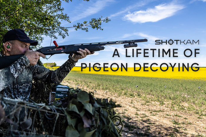 Gamekeeper Geoff Garrod aims his shotgun from a camouflaged hide during a day of pigeon decoying in the UK.