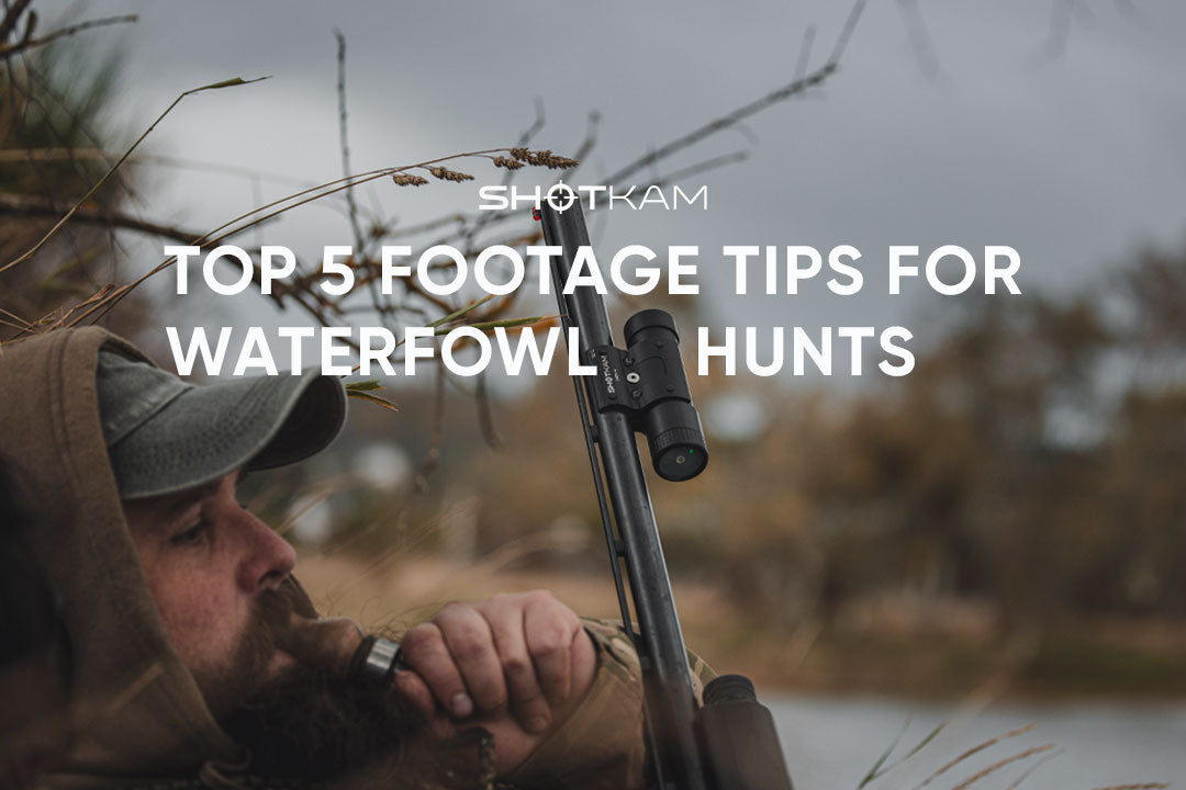 Waterfowl hunter aiming a shotgun equipped with a ShotKam camera during a duck hunt
