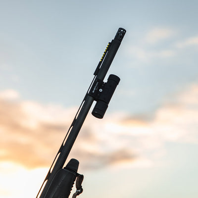 ShotKam Gen 4 mounted on a shotgun barrel, capturing a dynamic view against a scenic sky backdrop. Ideal for US clay shooters, bird hunters, and shooting enthusiasts who want to analyze their performance with crystal-clear video footage.