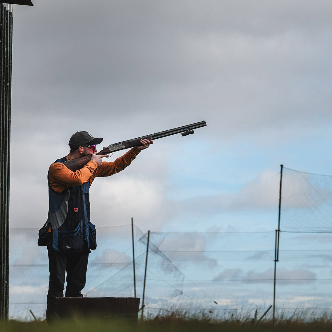 Shooter tracking a clay target with a 12-gauge shotgun mounted with the ShotKam Gen 4 Mini. Ideal for shotgun sports, target shooting, and training.