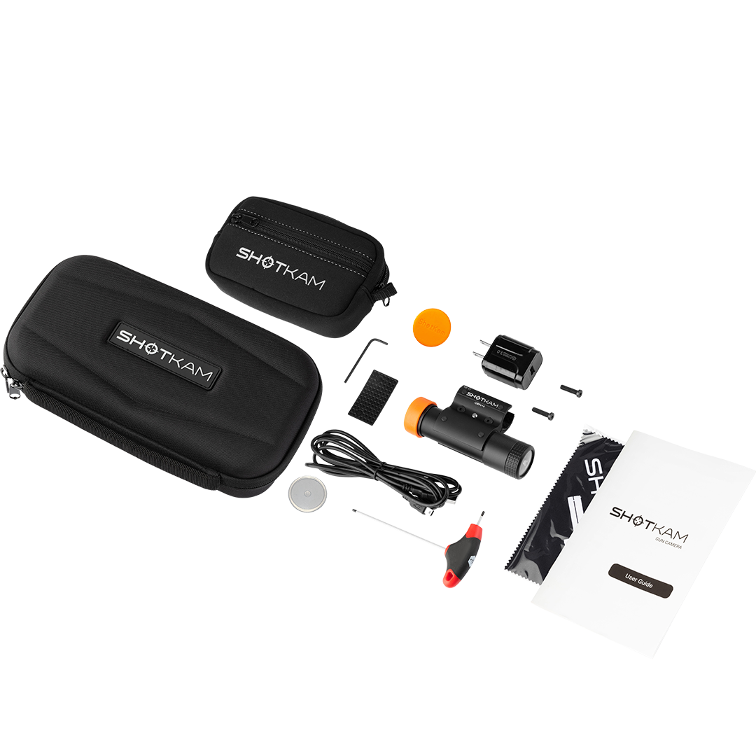 ShotKam Gen 4 complete kit for shotgun and rifle shooters in the USA. Includes the ShotKam Gen 4 camera, protective carrying cases, mounting bracket, charging cable, lens covers, user guide, and cleaning cloth. Designed for capturing high-definition shooting footage with precision and durability.