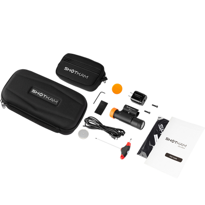 ShotKam Gen 4 complete kit for shotgun and rifle shooters in the USA. Includes the ShotKam Gen 4 camera, protective carrying cases, mounting bracket, charging cable, lens covers, user guide, and cleaning cloth. Designed for capturing high-definition shooting footage with precision and durability.